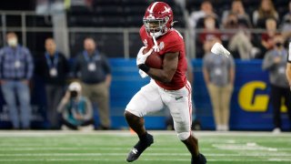 Alabama running back Brian Robinson Jr. (4) runs for a gain against Cincinnati during the first half of the Cotton Bowl NCAA College Football Playoff semifinal game, Friday, Dec. 31, 2021, in Arlington, Texas.