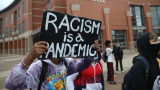 racism is a pandemic as dozens of Quincy High School students walk out