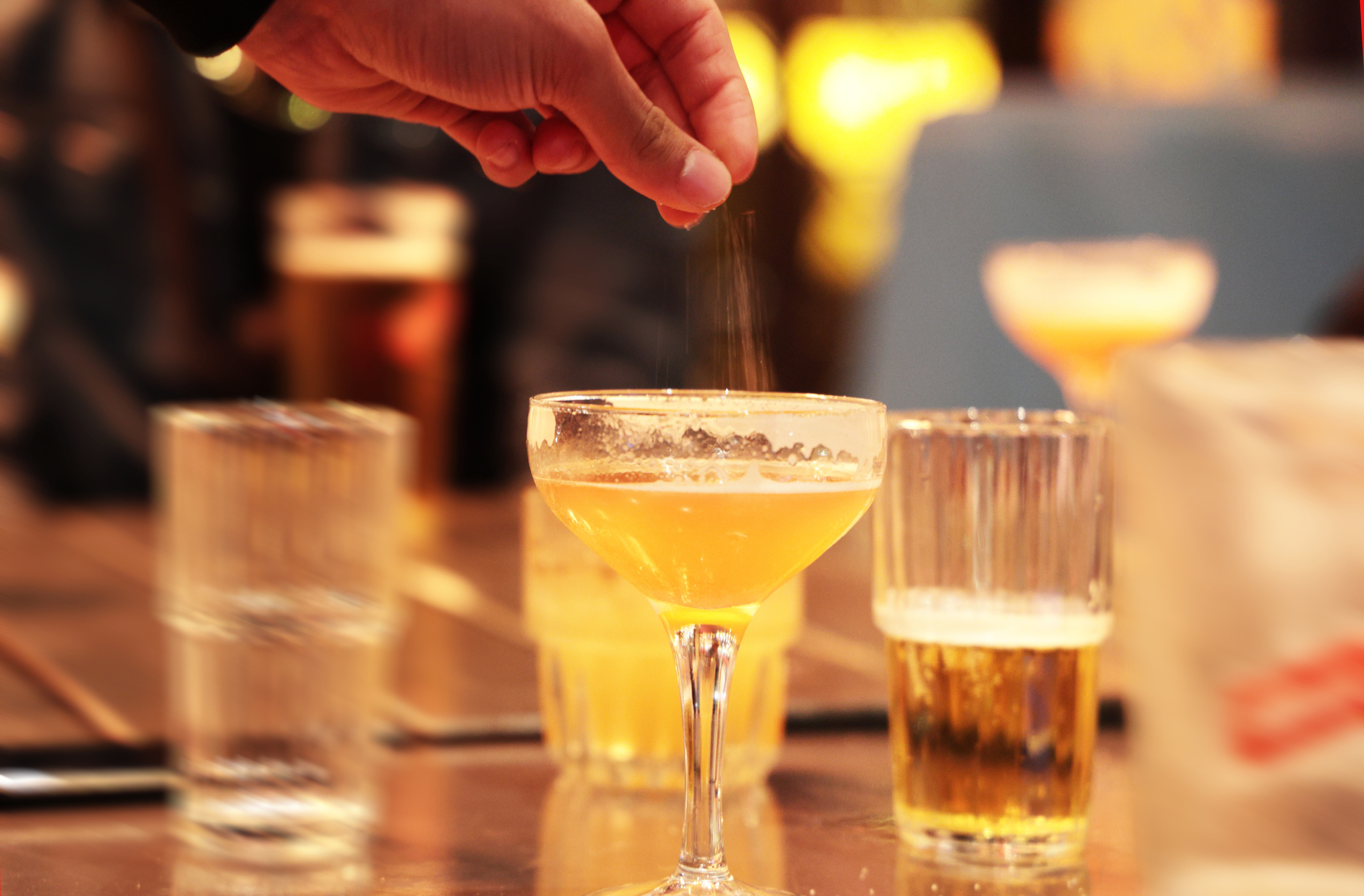 A file photo showing a person appearing to sprinkle drugs into a drink at a bar