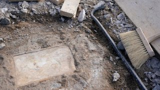 FILE - A time capsule that was placed in 1887 in the pedestal that once held the statue of Confederate General Robert E. Lee is uncovered on Monument Avenue, Dec. 17, 2021, in Richmond, Va.