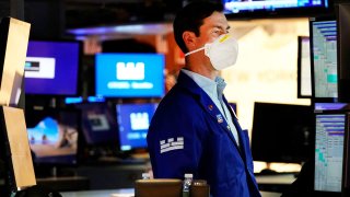 A trader works on the floor of the New York Stock Exchange at the closing bell January 14, 2022, in New York.