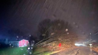 authorities closed down a road after power lines came down and homes suffered damage early Sunday, Jan. 2, 2022 in Hazel Green, Ala.