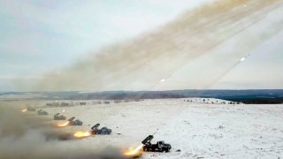 FILE – In this image taken from video and released by Russian Defense Ministry Press Service, Russian rocket launchers fire during military drills near Orenburg in the Urals, Russia, Dec. 16, 2021.