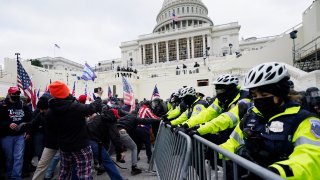 Trump supporters try to break through a police barrier, Wednesday, Jan. 6, 2021, at the Capitol in Washington. As Congress prepares to affirm President-elect Joe Biden's victory, thousands of people have gathered to show their support for President Donald Trump and his claims of election fraud.