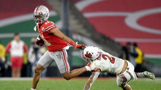Jaxon Smith-Njigba #11 of the Ohio State Buckeyes carries the ball after a reception against the Utah Utes during the second half in the Rose Bowl Game at Rose Bowl Stadium on January 01, 2022 in Pasadena, California.