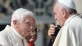 Pope emeritus Benedict XVI (L) speaks with Pope Francis