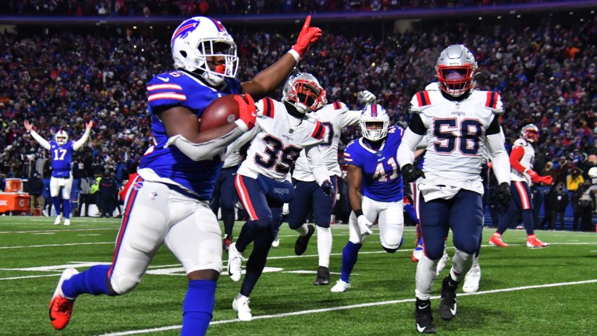 Jan 15, 2022; Orchard Park, New York, USA; Buffalo Bills running back Devin Singletary (26) runs for a touchdown during the second quarter of the AFC Wild Card playoff game against the New England Patriots at Highmark Stadium. Mandatory Credit: Mark Konezny-USA TODAY Sports