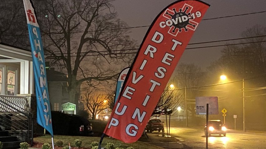Signs advertise Covid-19 testing available at Park Pharmacy in Waterbury, but PCR tests were canceled after a lab backlog.