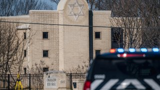 A law enforcement vehicle sits in front of the Congregation Beth Israel temple on Saturday in Colleyville, Texas, during a standoff.