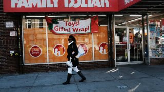 A woman walks by a Family Dollar store on December 11, 2018 in the Brooklyn borough of New York City.