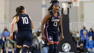 Connecticut's Christyn Williams (13) celebrates with Nika Mühl (10) after hitting a three point shot against Creighton