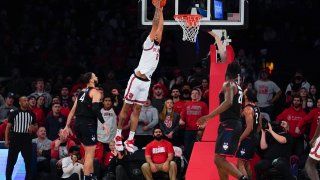 St. John's Julian Champagnie, top, dunks the ball during the first half of an NCAA college basketball game against Connecticut, Feb. 13, 2022, in New York.