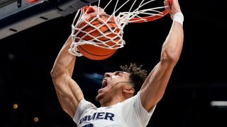 Xavier guard Colby Jones dunks during the first half of the team's NCAA college basketball game against Connecticut, Friday, Feb. 11, 2022, in Cincinnati.