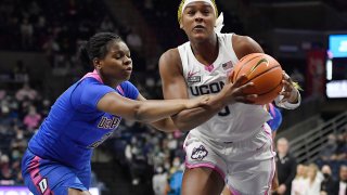 Connecticut's Aaliyah Edwards, right, is guarded by DePaul's Darrione Rogers, left, in the first half of an NCAA college basketball game, Friday, Feb. 11, 2022, in Storrs, Conn.