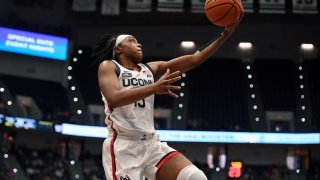 Connecticut's Christyn Williams goes up for a basket in the first half of an NCAA college basketball game against Georgetown, Feb. 20, 2022, in Hartford, Conn.