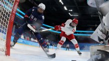 USA's Savannah Harmon, left, scores a goal past Russian Olympic Committee's goaltender Mariia Sorokina during the women's preliminary match for women's ice hockey at the Wukesong Sports Centre in Beijing, Feb. 5, 2022. The US shut out the ROC 5-0