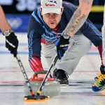 Team USA's John Shuster curls a stone during the men's round robin curling competition between the USA and the Russian Olympic Committee at the 2022 Winter Olympic Games, Feb. 9, 2022.