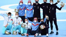 Team ROC (L), Team Norway (C) and Team USA (R) celebrate during the venue ceremony for the men's speed skating team pursuit event