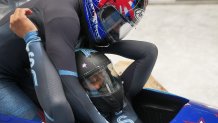 Elana Meyers Taylor, right, and Sylvia Hoffman celebrate their bronze medal win for 2-woman bobsled at the finish, Feb. 19, 2022, at the 2022 Winter Olympic Games in Beijing.