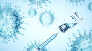 Digital generated image of syringe filling of COVID-19 vaccine from bottle against viruses on blue background.
