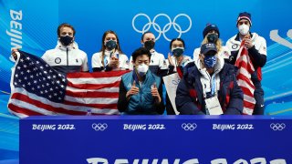 Nathan Chen of Team United States reacts with teammates following his skate in the Men's Single Skating Short Program Team Event during the Beijing 2022 Winter Olympic Games at Capital Indoor Stadium on February 04, 2022 in Beijing, China.