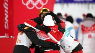 Team Austria celebrates after winning the Gold medal in the Men's Ski jumping