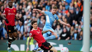 Kevin de Bruyne of Manchester City fires a shot at goal under pressure from Victor Lindelof of Manchester United during the Premier League match between Manchester City and Manchester United at Etihad Stadium on March 06, 2022 in Manchester, England.