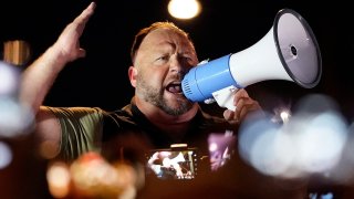 Infowars host and conspiracy theorist Alex Jones rallies pro-Trump supporters outside the Maricopa County Recorder's Office, Nov. 5, 2020, in Phoenix