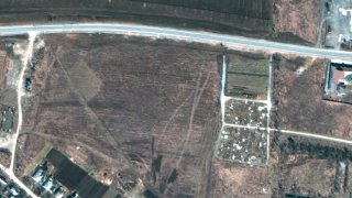 FILE - This satellite image provided by Maxar Technologies on Thursday, April 21, 2022 shows an overview of the cemetery in Manhush, some 20 kilometers west of Mariupol, Ukraine, on March 19, 2022.