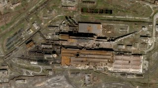 This satellite photo released by Planet Labs and taken on April 20, 2022 shows the Azovstal Steel Plant in Mariupol, Ukraine, with some large holes blasted in the roof.