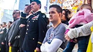 FILE - Former U.S. Air Force veteran and Iraq war double amputee Brian Kolfage, second from right, attends the National September 11 Memorial and Museum's "Salute to Service" tribute honoring U.S. veterans, Nov. 10, 2014 in New York. Kolfage, co-founder of the "We Build The Wall" project aimed at raising money for a border wall, has pleaded guilty, Thursday, April 21, 2022 to charges in a case that once included former President Donald Trump's adviser Steve Bannon.