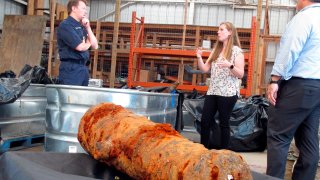 Commodore Philip Nash, left, of the British Royal Navy, gets a briefing from U.S. Army Corps of Engineers archaeologist Andrea Farmer on Thursday, April 28, 2022, in Savannah, Ga., about 19 cannons recovered from the Savannah River, that experts suspect came from one or more British ships scuttled in the river during the American Revolution in 1779.