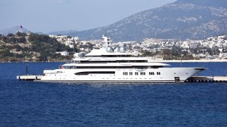 MUGLA, TURKEY - FEBRUARY 18: The 106m-long and 18m-high super luxury motor yacht Amadea, one of the largest yacht in the world is seen after anchored at pier in Pasatarlasi for bunkering with 9 fuel trucks, on February 18, 2020 in Bodrum district of Mugla province in Turkey. Amadea, the Cayman-flagged motor yacht, arrived from France and entered in Turkey passing through Greece. Amadeus's interior layout sleeps up to 16 guests in 8 cabins, including a master suite, a VIP stateroom, with a helipad.