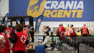 Red Cross workers tend to Ukrainian refugees at a center at the Fira de Barcelona, April 8, 2022, in Barcelona, Catalonia, Spain.