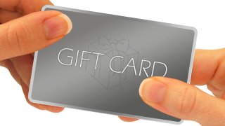 A gift card being exchanged through hands