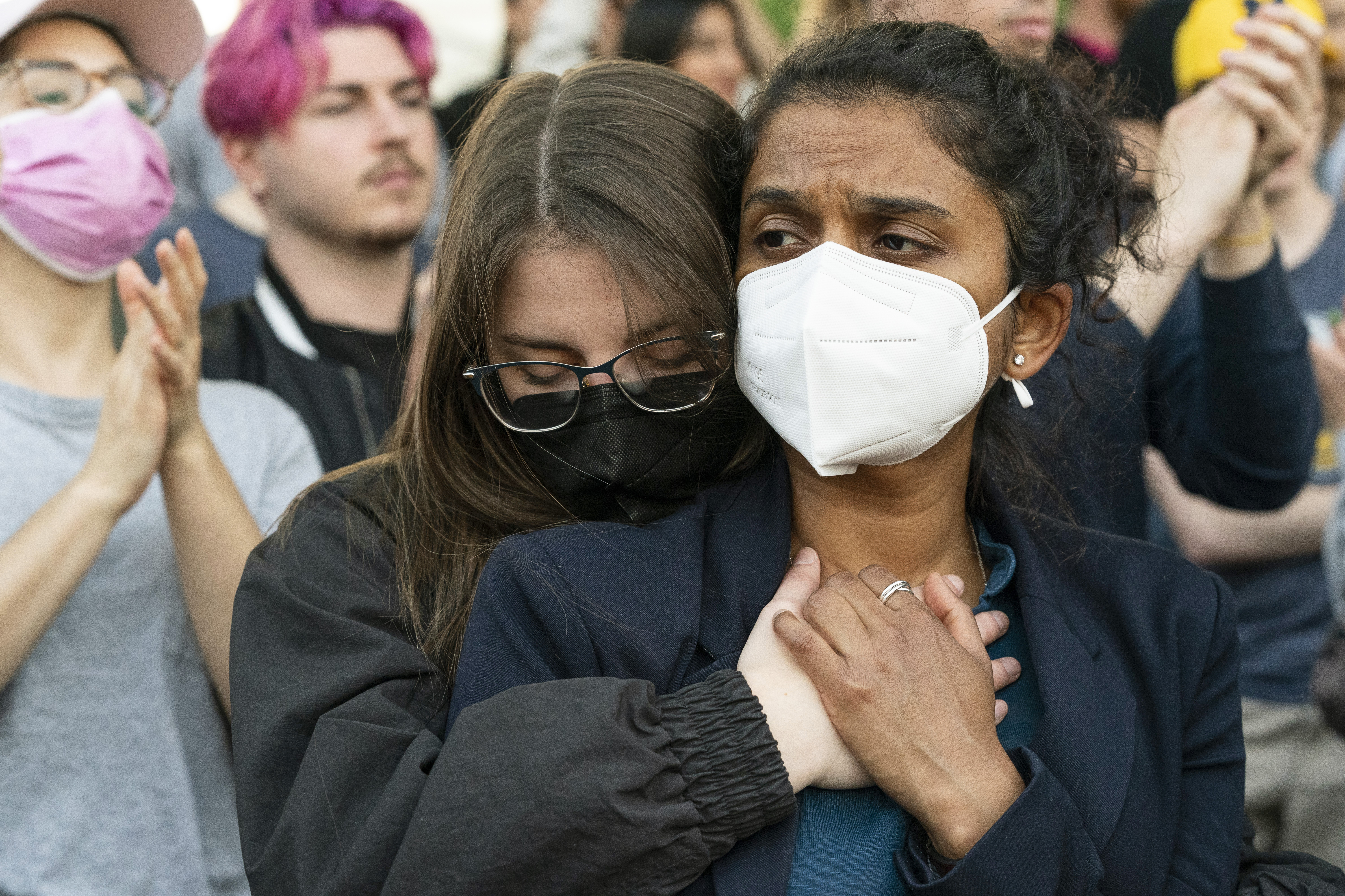 Protesters embrace as demonstrators protest outside of the U.S. Supreme Court Tuesday, May 3, 2022 in Washington.