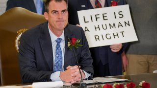 Oklahoma Gov. Kevin Stitt speaks after signing into law a bill making it a felony to perform an abortion, punishable by up to 10 years in prison on April 12, 2022, in Oklahoma City.