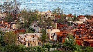 Heavily-damaged private houses are seen on the shore of the Sea of Azov in Mariupol, in territory under the government of the Donetsk People's Republic, eastern Ukraine, Saturday, May 21, 2022.