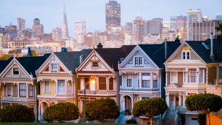 The iconic painted ladies houses with San Francisco downtown skyline in the distance