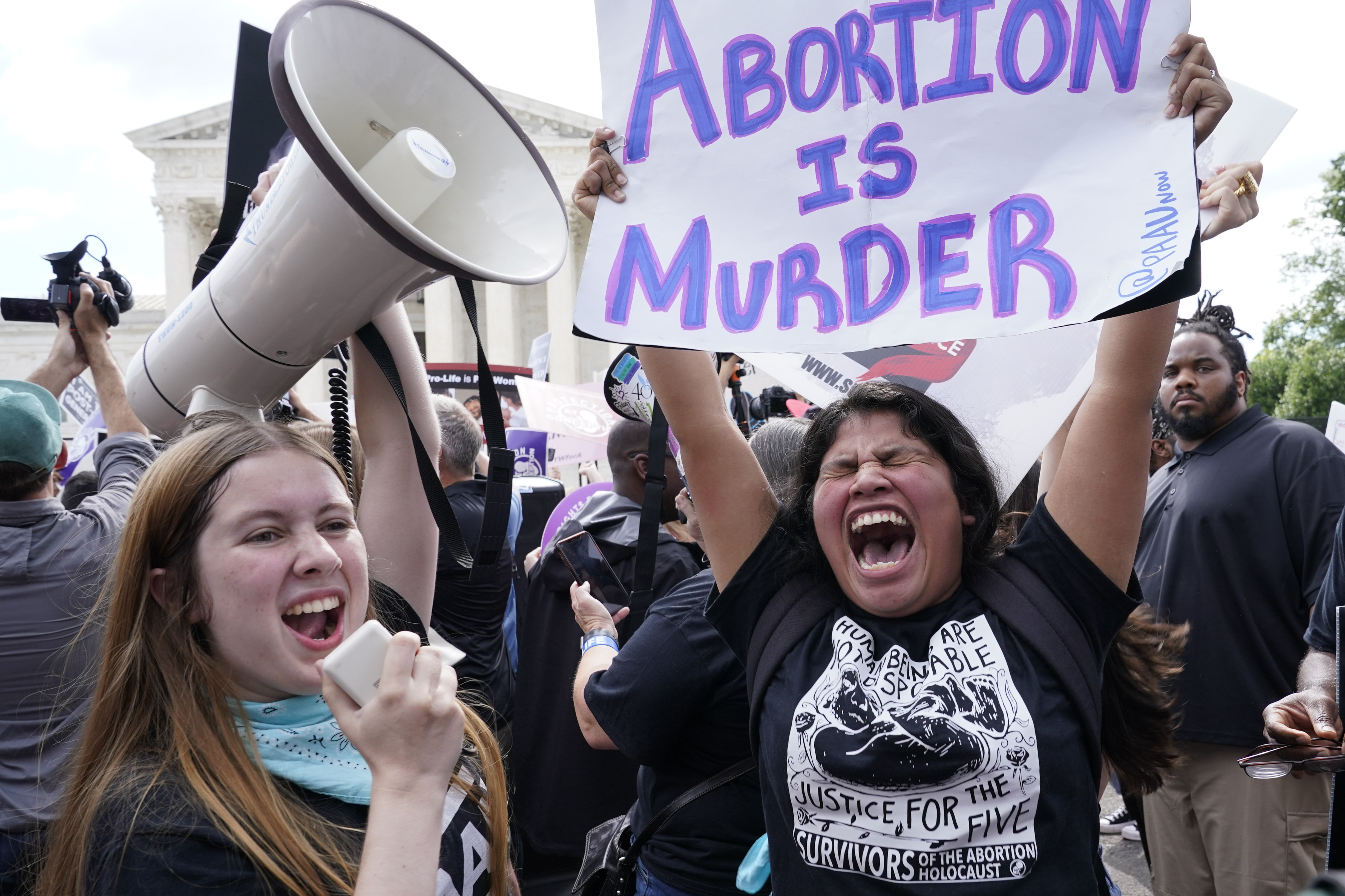 People celebrate outside the Supreme Court, Friday, June 24, 2022, in Washington.