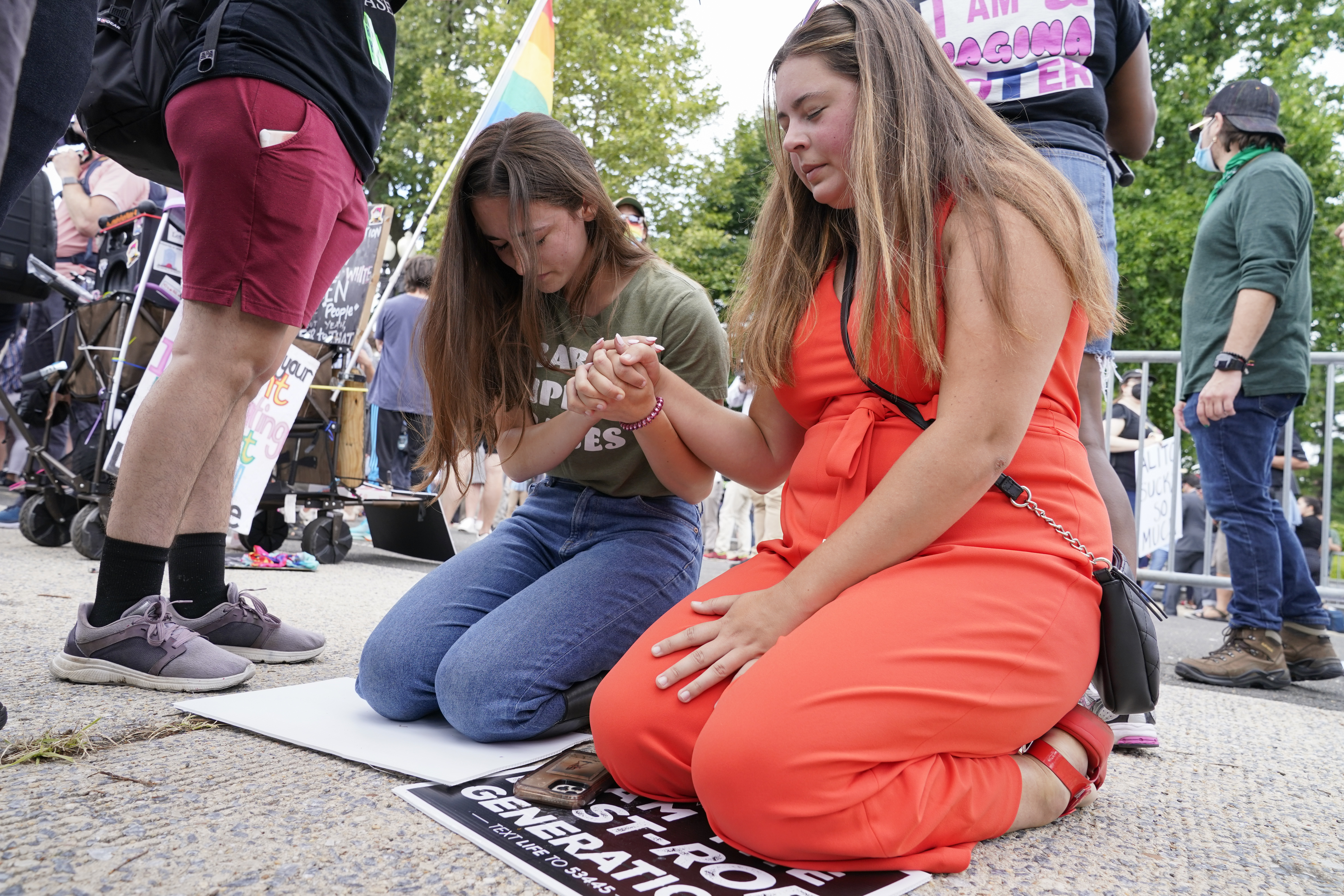 Anti-abortion activists Maggie Donica, 21, right, and Grace Rykaczewski, 21, left, pray following the Supreme Court’s decision to overturn Roe v. Wade, federally protected right to abortion, in Washington, Friday, June 24, 2022.