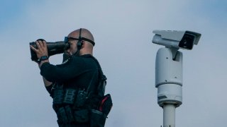 A member of the US Secret Service looks out from the roof of the White House in Washington, DC on August 21, 2021.