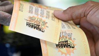 A customer at the 7-Eleven on Chino Hills Parkway in Chino Hills receives there lottery tickets on Wednesday, July 27, 2022 where Fridays Mega Millions payout is expected to exceed $1 billion.