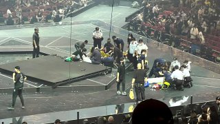 Two dancers receive medical treatment at a concert of Cantopop boy band Mirror in Hong Kong, Thursday, July 28, 2022.