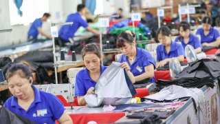 Pictured here on June 24, 2022, are workers making umbrellas in a factory in Jinjiang city, Fujian province, China.