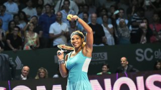 Serena Williams waves to spectators after defeating Eugenie Bouchard of Canada during the Women’s Tennis Association finals round robin match in Singapore on October 23, 2014.