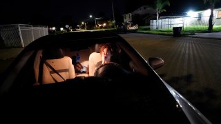 Jada Riley sits in her car at night