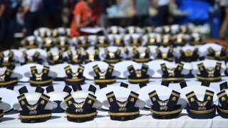 The new hats and shoulder bars for the graduates sit on a table before the start of the U.S. Coast Guard Academy's 141st Commencement Exercises Wednesday, May 18, 2022 in New London, Conn.
