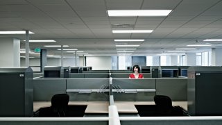 Businesswoman standing alone in empty office