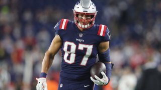 Rob Gronkowski in football gear, walking toward the camera